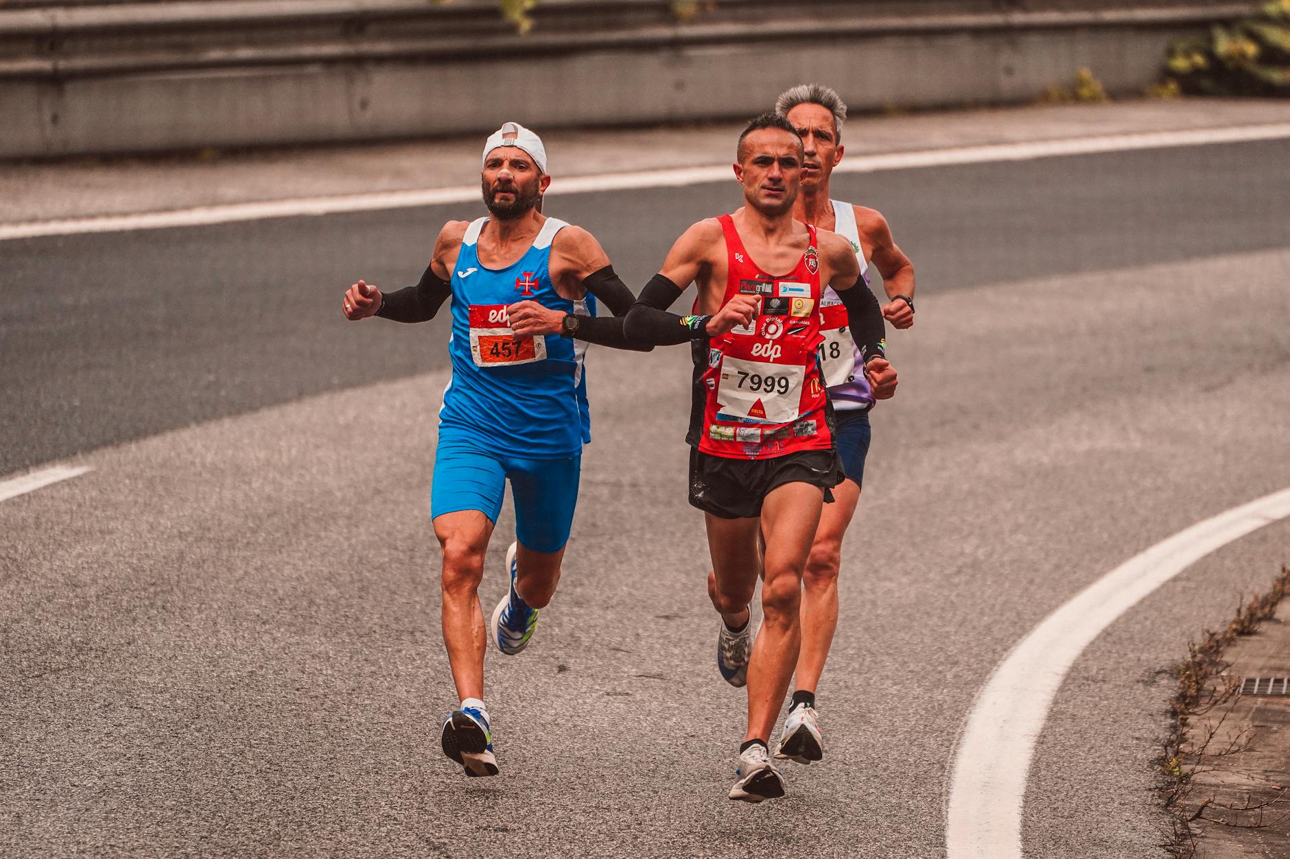 runner over 40 in good form on park path, determined expression