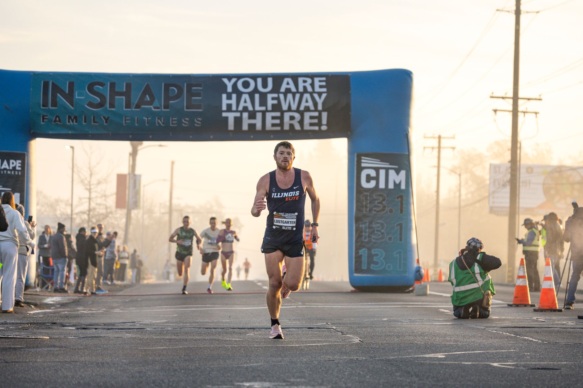 finish line of half marathon race, amateur runner crossing tape