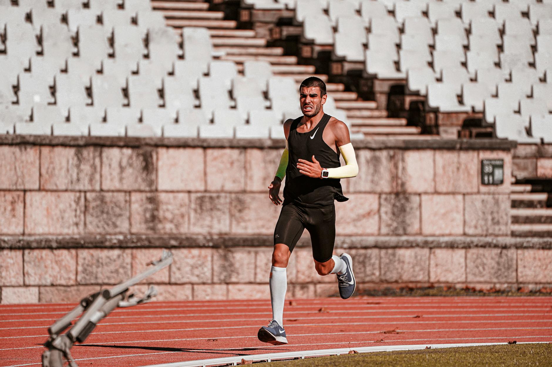 runner doing single-leg strength exercises outdoors, focused form