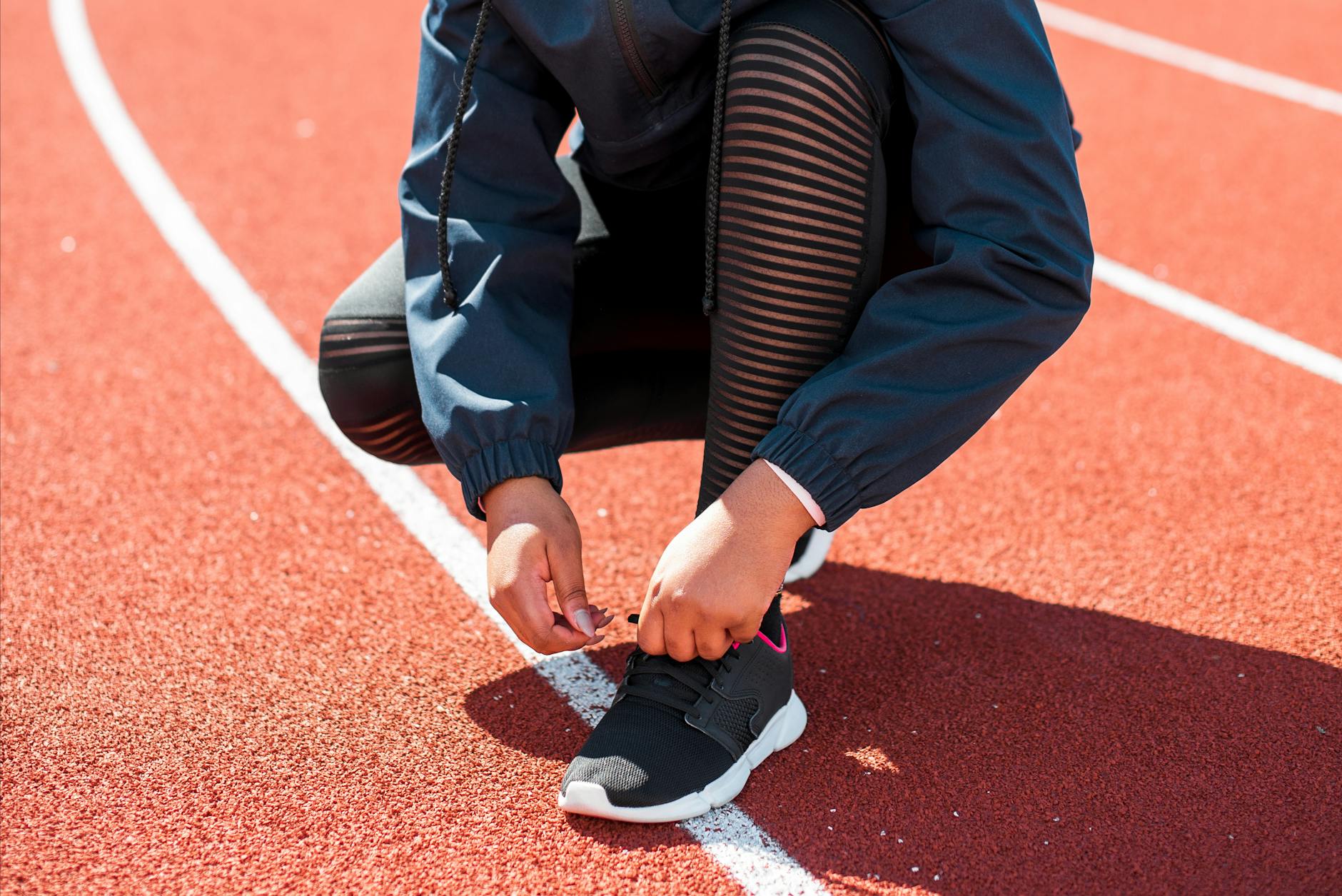 runner with blisters removing wrong shoes, pained expression