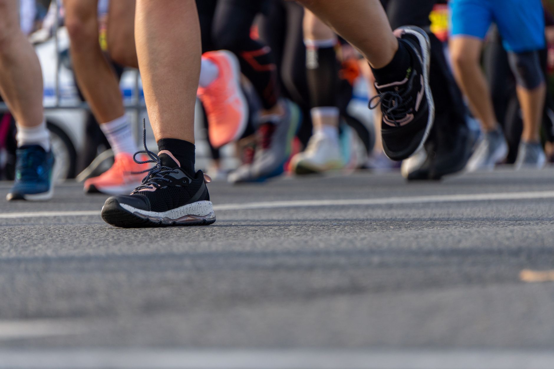 closeup of runner applying protective tape to foot, pre-race ritual