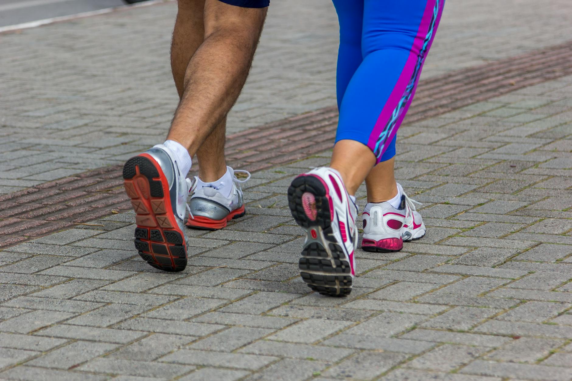 beginner runner alternating walk and jog on park path, relaxed expression